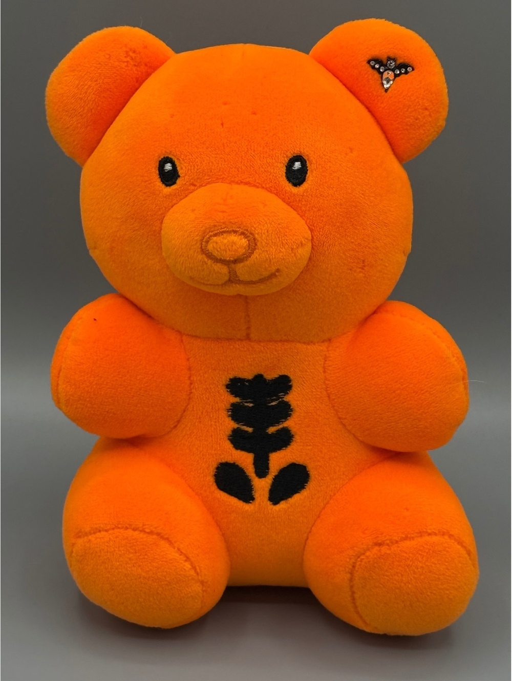 Orange Plush Teddy Bear with Decorative Bat Pin